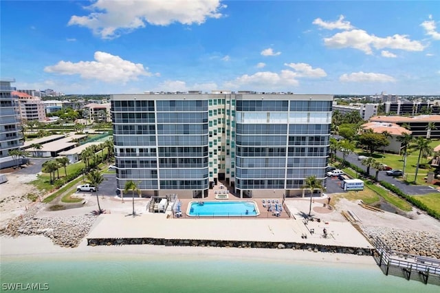 view of property featuring a water view and a beach view