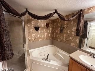 bathroom featuring tile patterned floors, a textured ceiling, independent shower and bath, and vanity