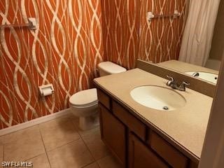 bathroom featuring tile patterned flooring, vanity, toilet, and a shower with curtain