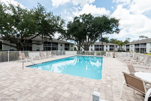 view of swimming pool with a patio