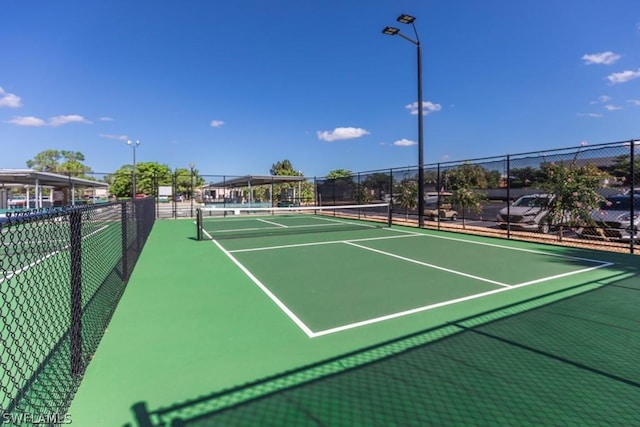 view of tennis court featuring basketball court