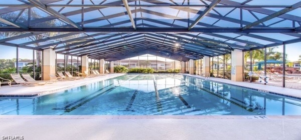 view of pool featuring glass enclosure