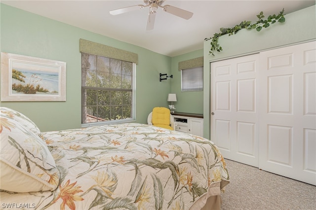 carpeted bedroom featuring a closet and ceiling fan