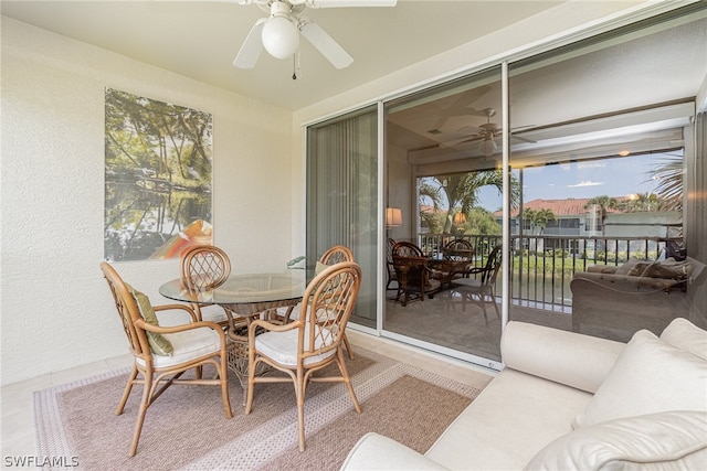 sunroom / solarium featuring ceiling fan