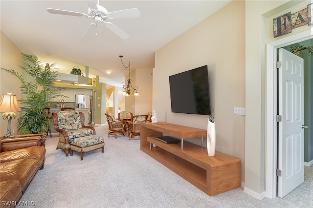 living room featuring carpet, ceiling fan with notable chandelier, and vaulted ceiling