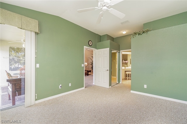 unfurnished bedroom featuring carpet flooring, lofted ceiling, and ceiling fan