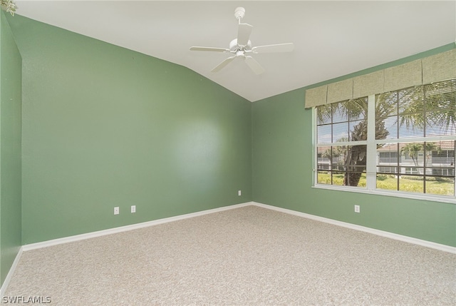 carpeted empty room featuring vaulted ceiling and ceiling fan