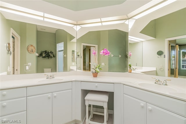 bathroom with vanity with extensive cabinet space and double sink