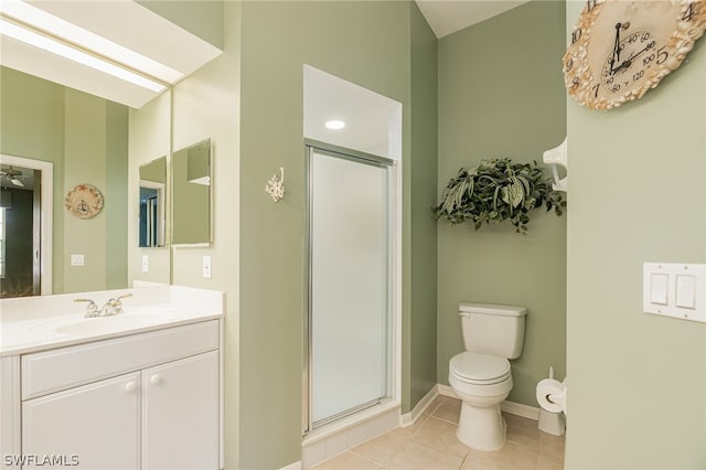 bathroom featuring tile floors, a shower with shower door, oversized vanity, and toilet