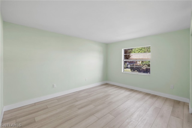 unfurnished room with light hardwood / wood-style floors