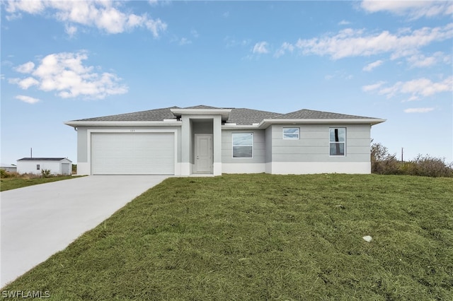 view of front of property featuring a garage and a front yard