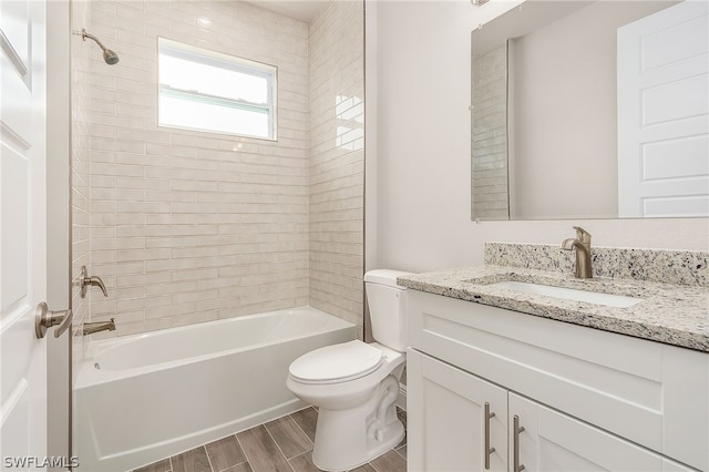 full bathroom with vanity, toilet, and tiled shower / bath