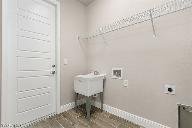 clothes washing area featuring hookup for an electric dryer, wood-type flooring, and hookup for a washing machine