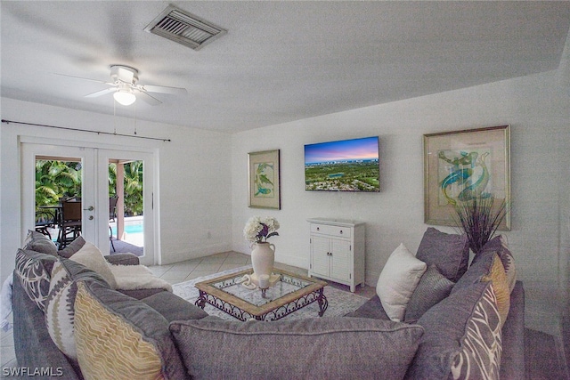 living room with french doors, ceiling fan, and tile floors