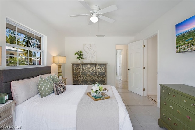 bedroom with ceiling fan and light tile flooring