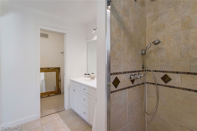 bathroom with tile floors, tiled shower, and oversized vanity