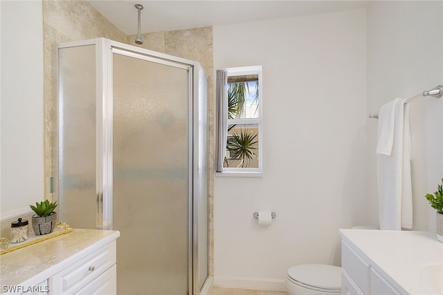 bathroom featuring a shower with door, toilet, and vanity