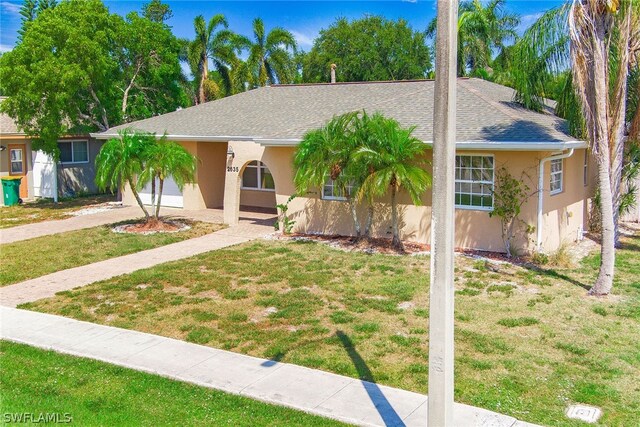 single story home featuring a front yard