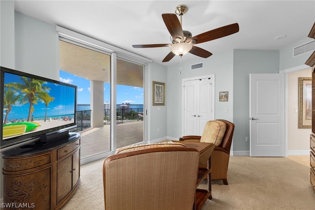 interior space with ceiling fan and a wall of windows