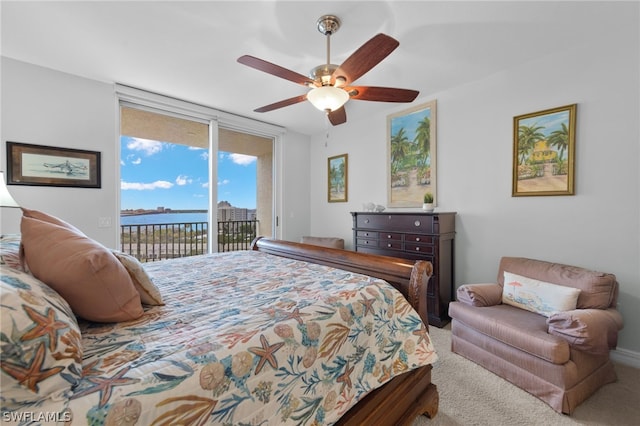 bedroom with floor to ceiling windows, a water view, access to outside, ceiling fan, and carpet