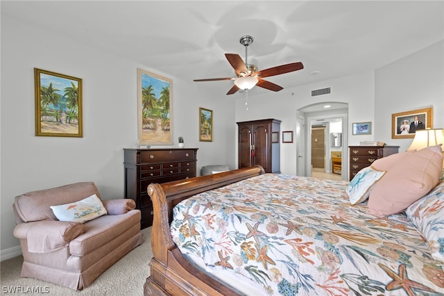 carpeted bedroom featuring ceiling fan and ensuite bathroom