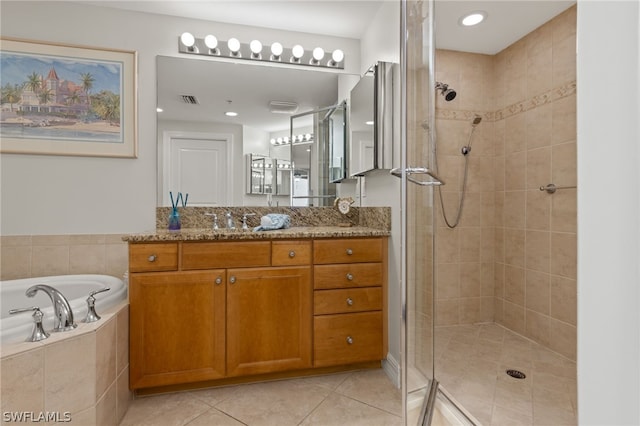 bathroom with vanity, tile patterned floors, and independent shower and bath