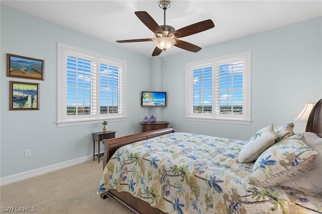 bedroom featuring multiple windows, carpet flooring, and ceiling fan