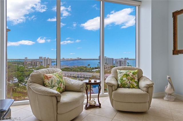 interior space with a water view and light tile patterned floors