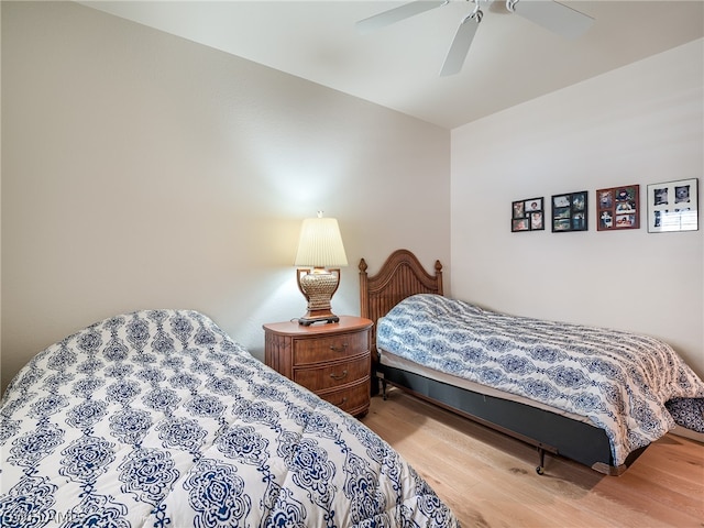 bedroom with hardwood / wood-style flooring and ceiling fan