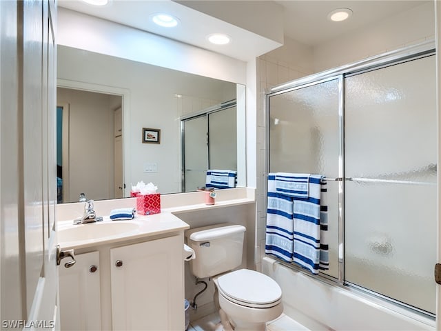 full bathroom with vanity, toilet, and enclosed tub / shower combo