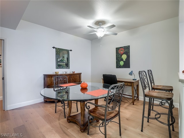 dining area with hardwood / wood-style flooring and ceiling fan