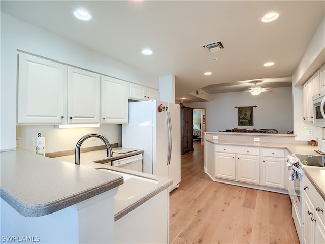 kitchen featuring white cabinetry, white refrigerator, kitchen peninsula, electric stove, and light wood-type flooring