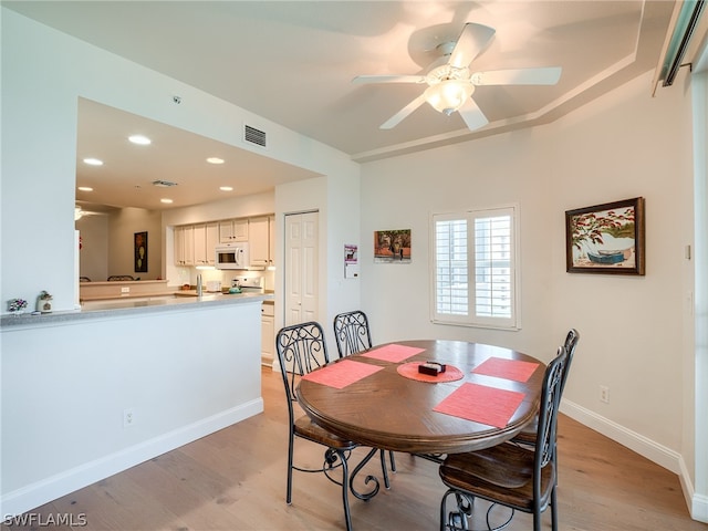 dining area featuring ceiling fan and light wood-type flooring