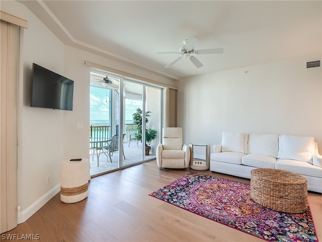 living room with ceiling fan and hardwood / wood-style floors