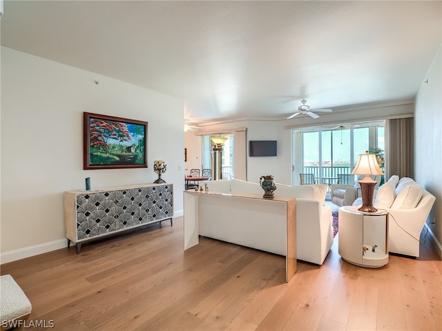 living room with wood-type flooring and ceiling fan