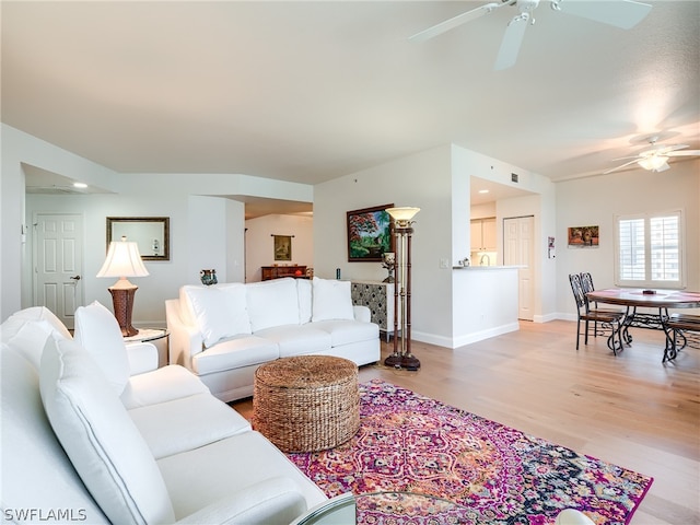 living room featuring ceiling fan and light wood-type flooring