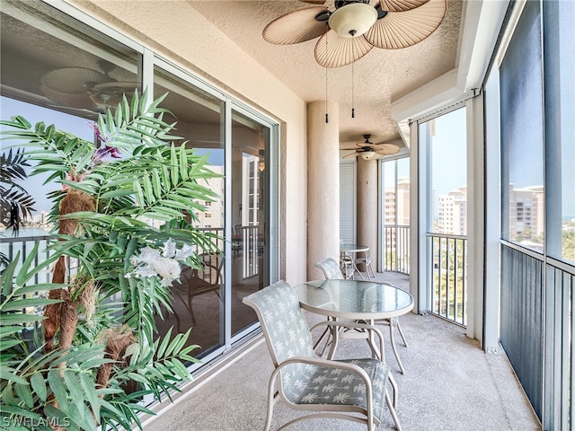 sunroom featuring ceiling fan