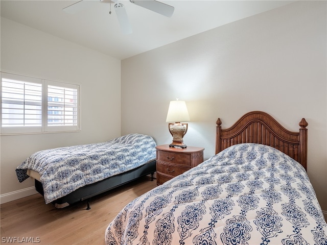 bedroom with ceiling fan and light hardwood / wood-style floors