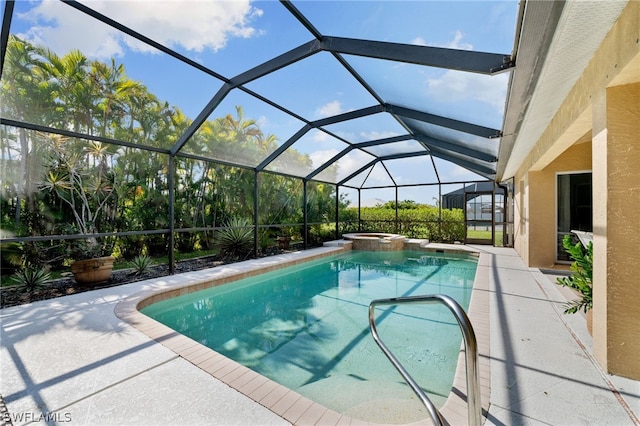 view of swimming pool featuring an in ground hot tub, a lanai, and a patio