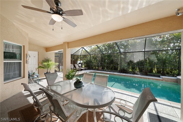 view of pool featuring ceiling fan, a lanai, and a patio area