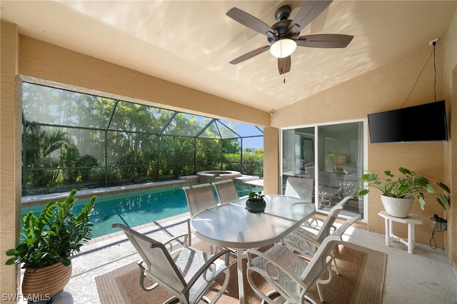 view of swimming pool featuring ceiling fan, a patio area, glass enclosure, and an in ground hot tub