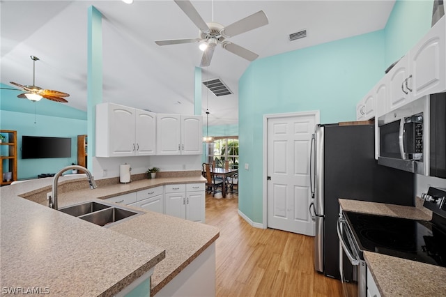 kitchen with sink, white cabinetry, vaulted ceiling, ceiling fan, and stainless steel appliances