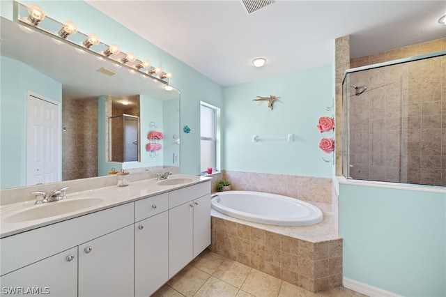 bathroom with vanity, plus walk in shower, and tile patterned flooring