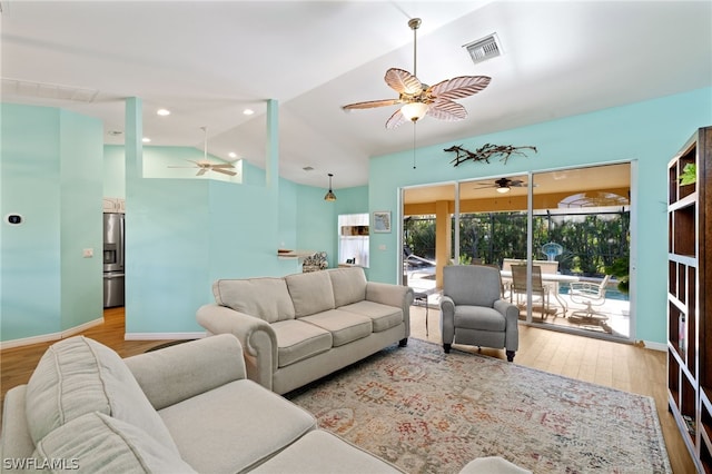 living room with lofted ceiling, light hardwood / wood-style flooring, and ceiling fan