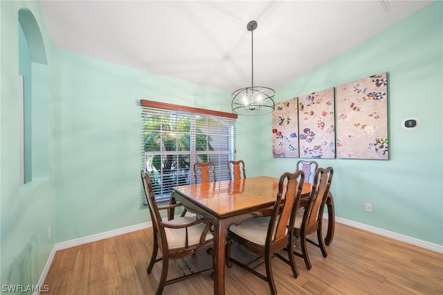 dining room featuring wood-type flooring and a chandelier