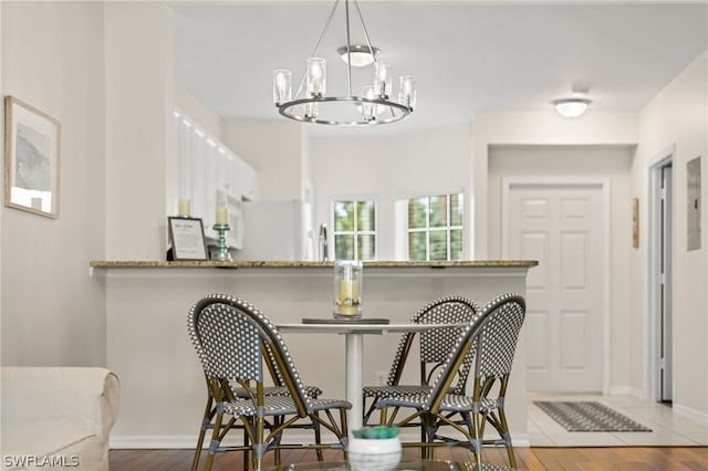 dining room featuring a notable chandelier and wood-type flooring