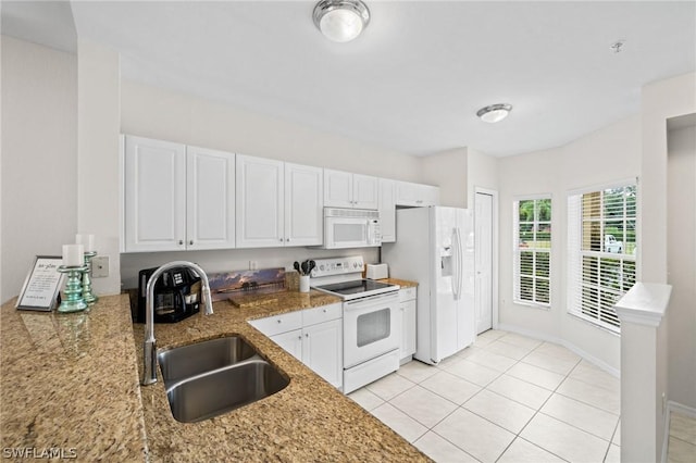 kitchen featuring sink, white cabinets, and white appliances