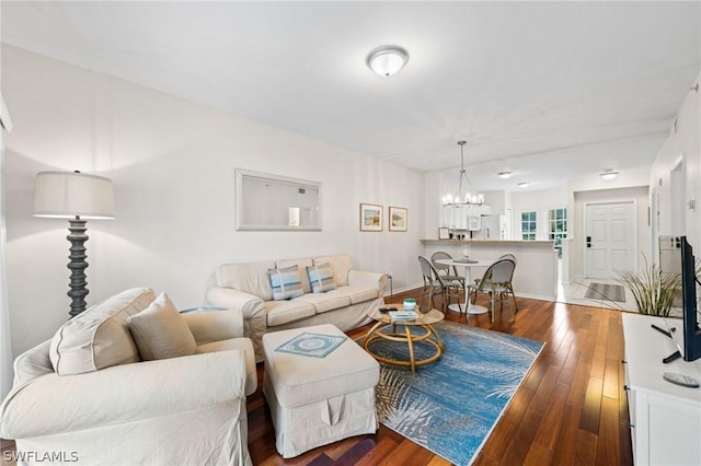 living room featuring an inviting chandelier and hardwood / wood-style floors