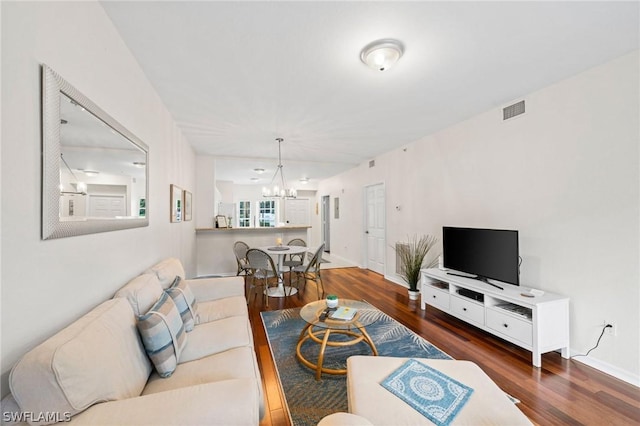 living room featuring a notable chandelier and hardwood / wood-style floors