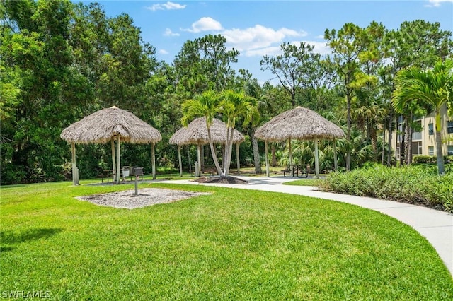 view of property's community with a lawn and a gazebo